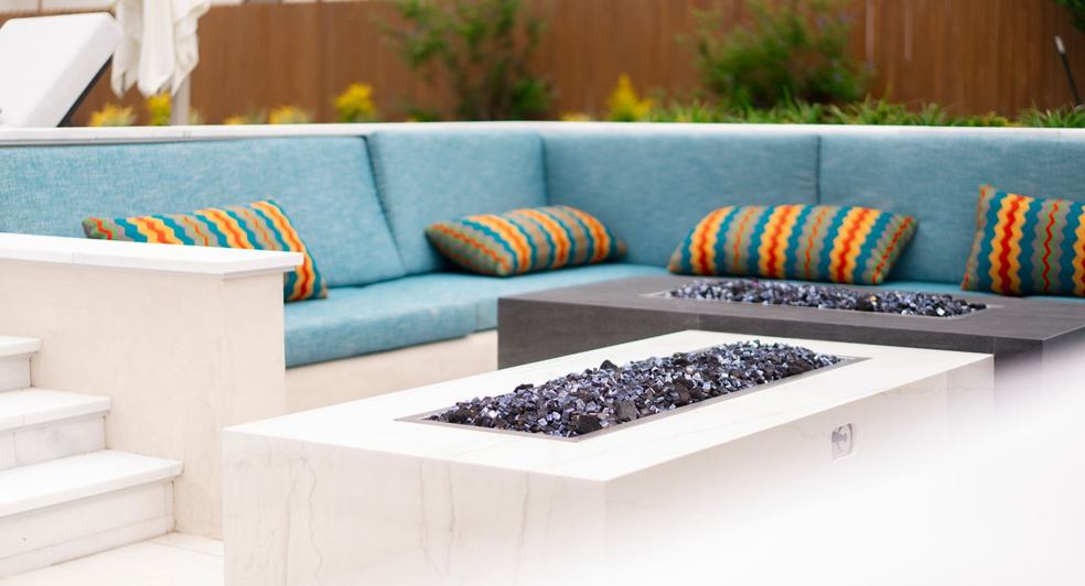 Outdoor living room with sofas and a fire pit