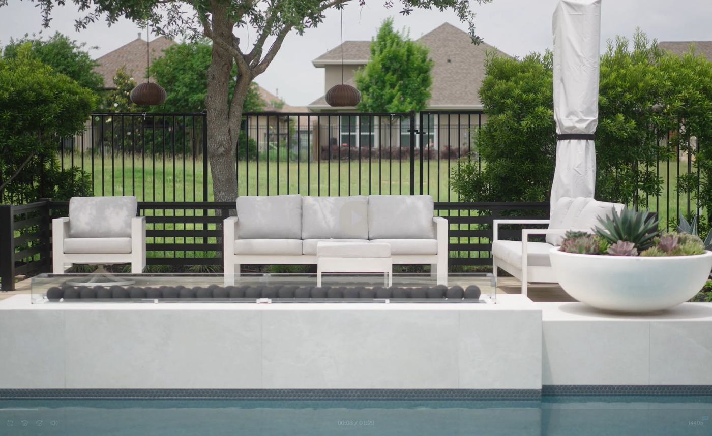 Custom patio and deck beside the home with seating