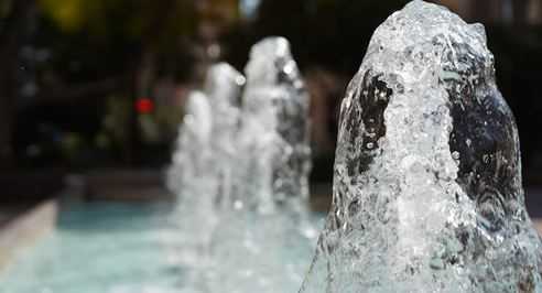 Water jets rising from a custom pool fountain