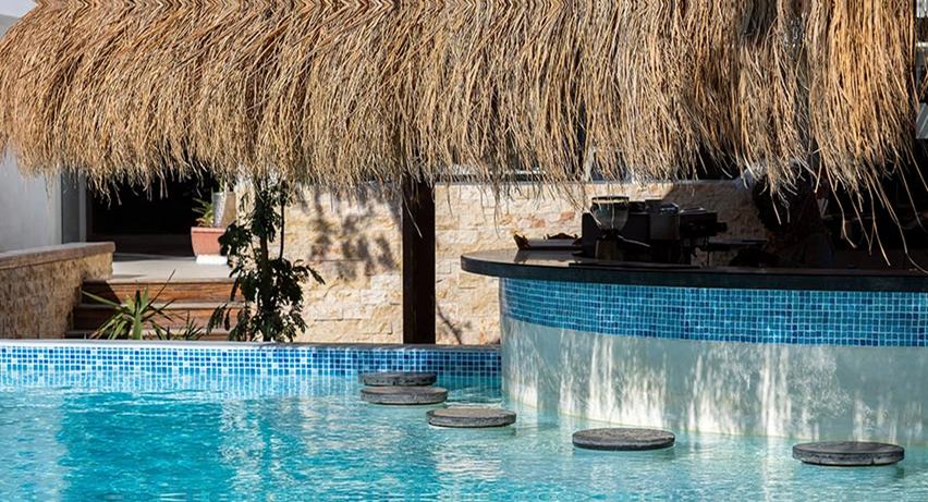 Swim-up bar with stools set into a resort pool