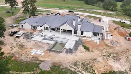 Aerial view of a large estate home site under construction