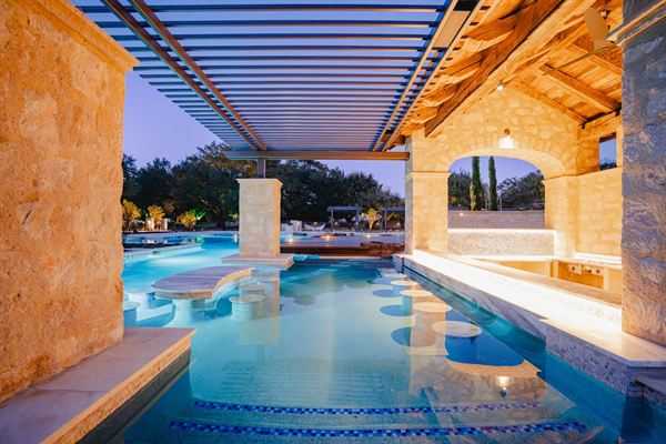 Custom pergola covering a poolside seating area