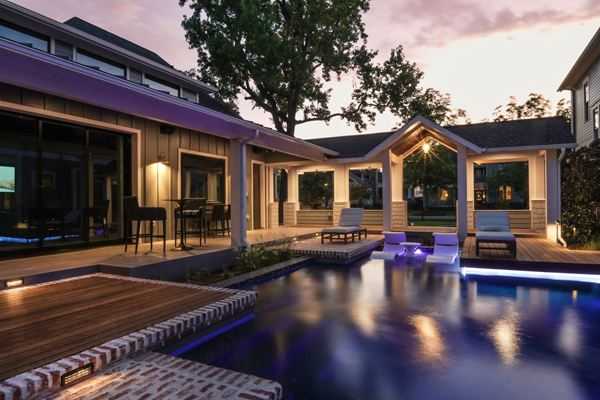 Luxury residential pool beside a covered patio